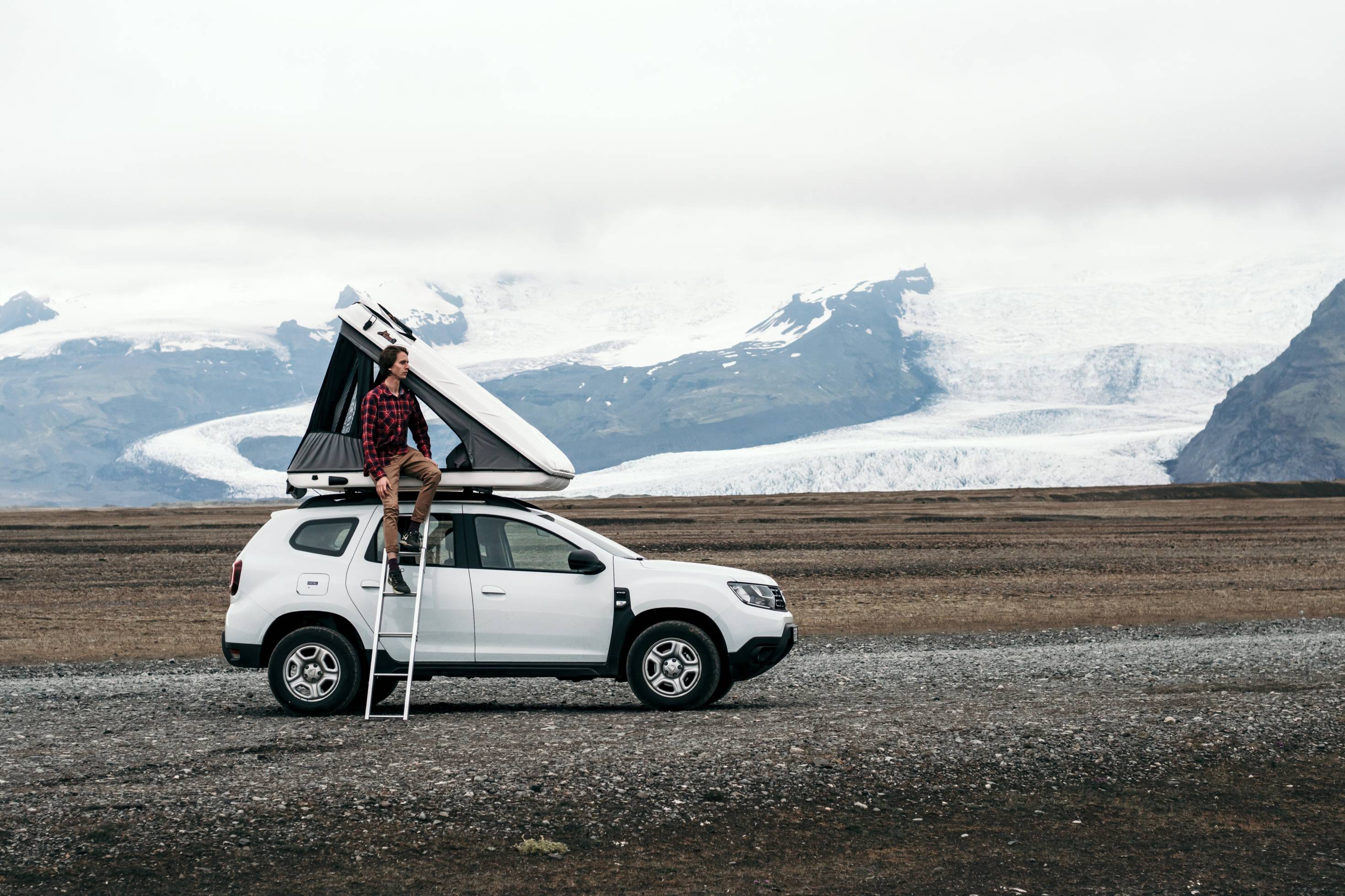 Man by Roof Tent Vehicle