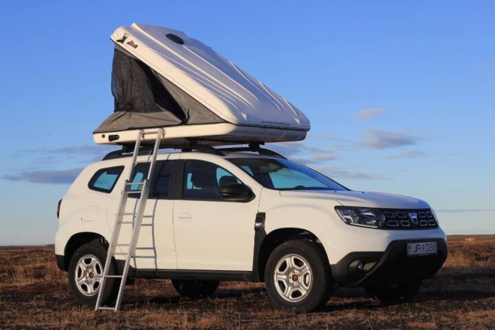 Dacia Duster with roof tent open with ladder