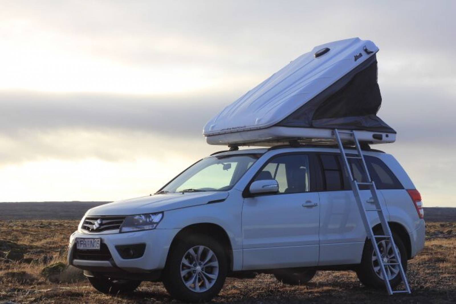 Grand Vitara with roof tent open with ladder